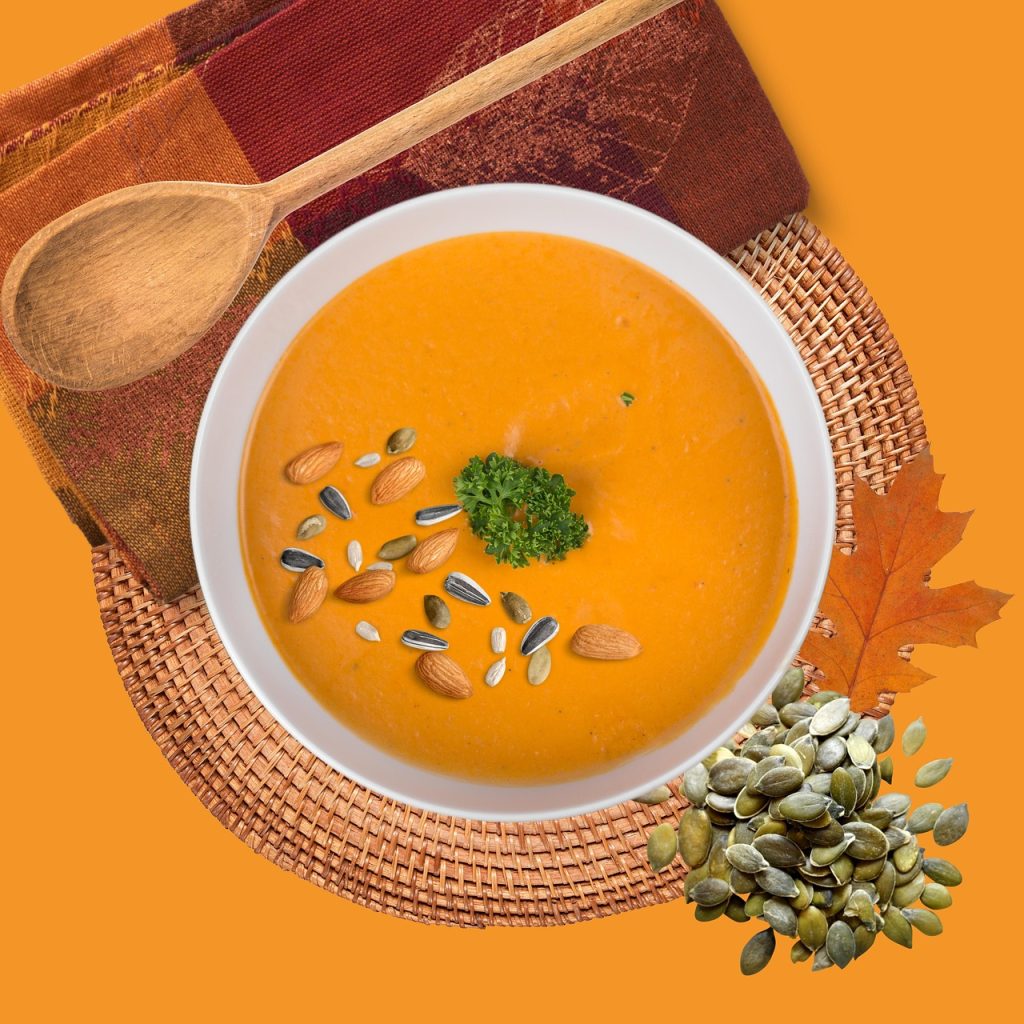 Autumn pumpkin soup topped with nuts and seeds, symbolizing healthy fall nutrition and weight loss counseling support